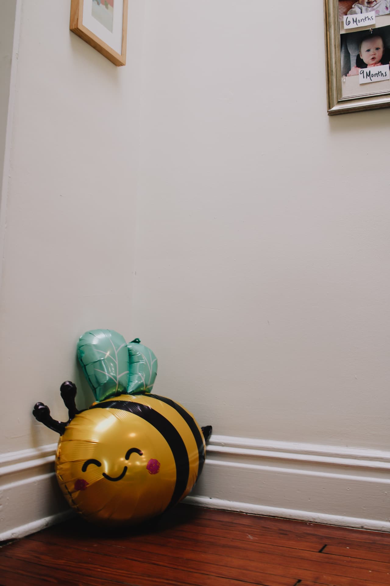 Smiling bumblebee balloon on the hardwood floor